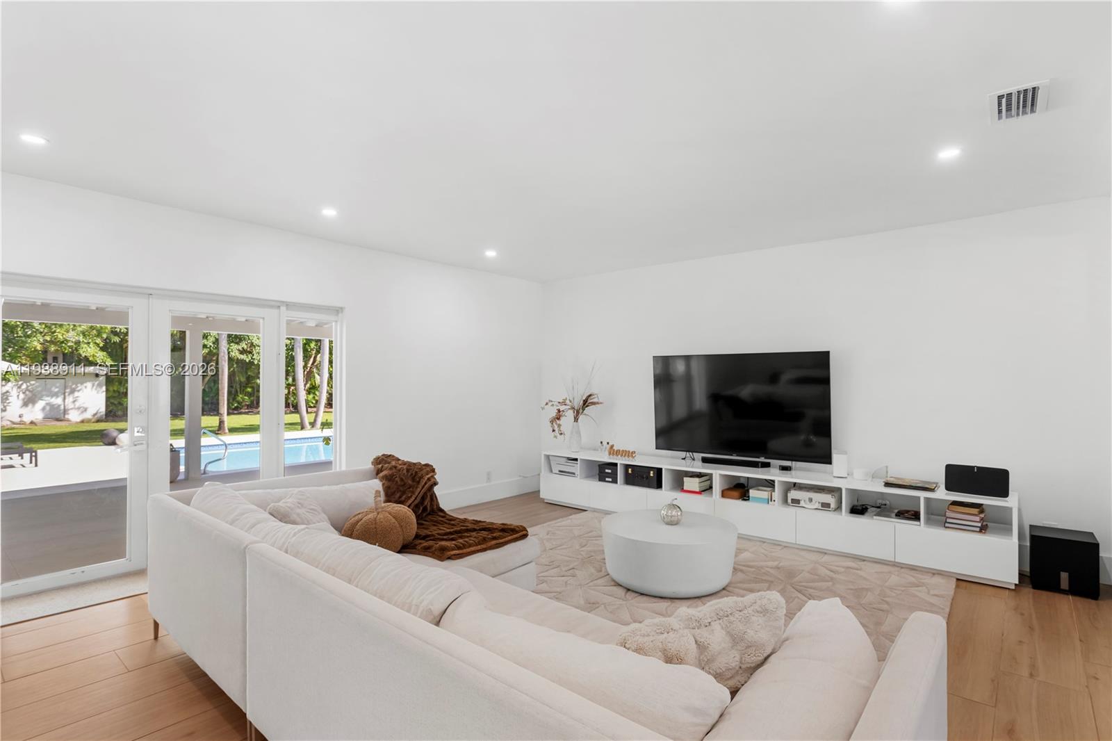7825 Southwest 72nd Avenue Miami, FL 33143 - Photo 17 of 30 a living room with furniture and a flat screen tv