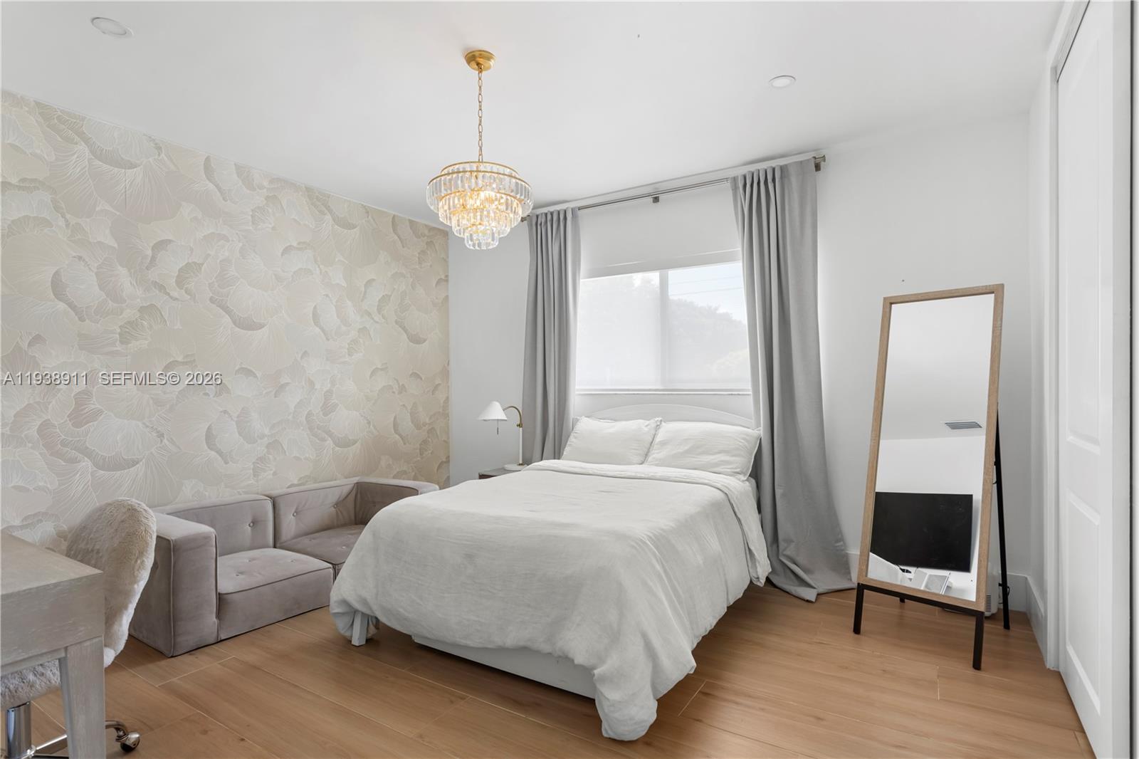 7825 Southwest 72nd Avenue Miami, FL 33143 - Photo 27 of 30 a bedroom with a bed and a chandelier