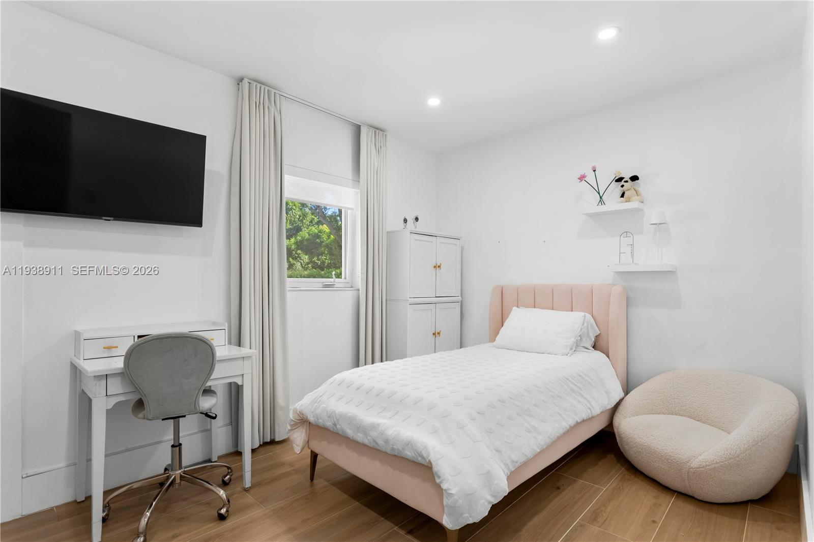 7825 Southwest 72nd Avenue Miami, FL 33143 - Photo 28 of 30 a bedroom with a bed and a chair