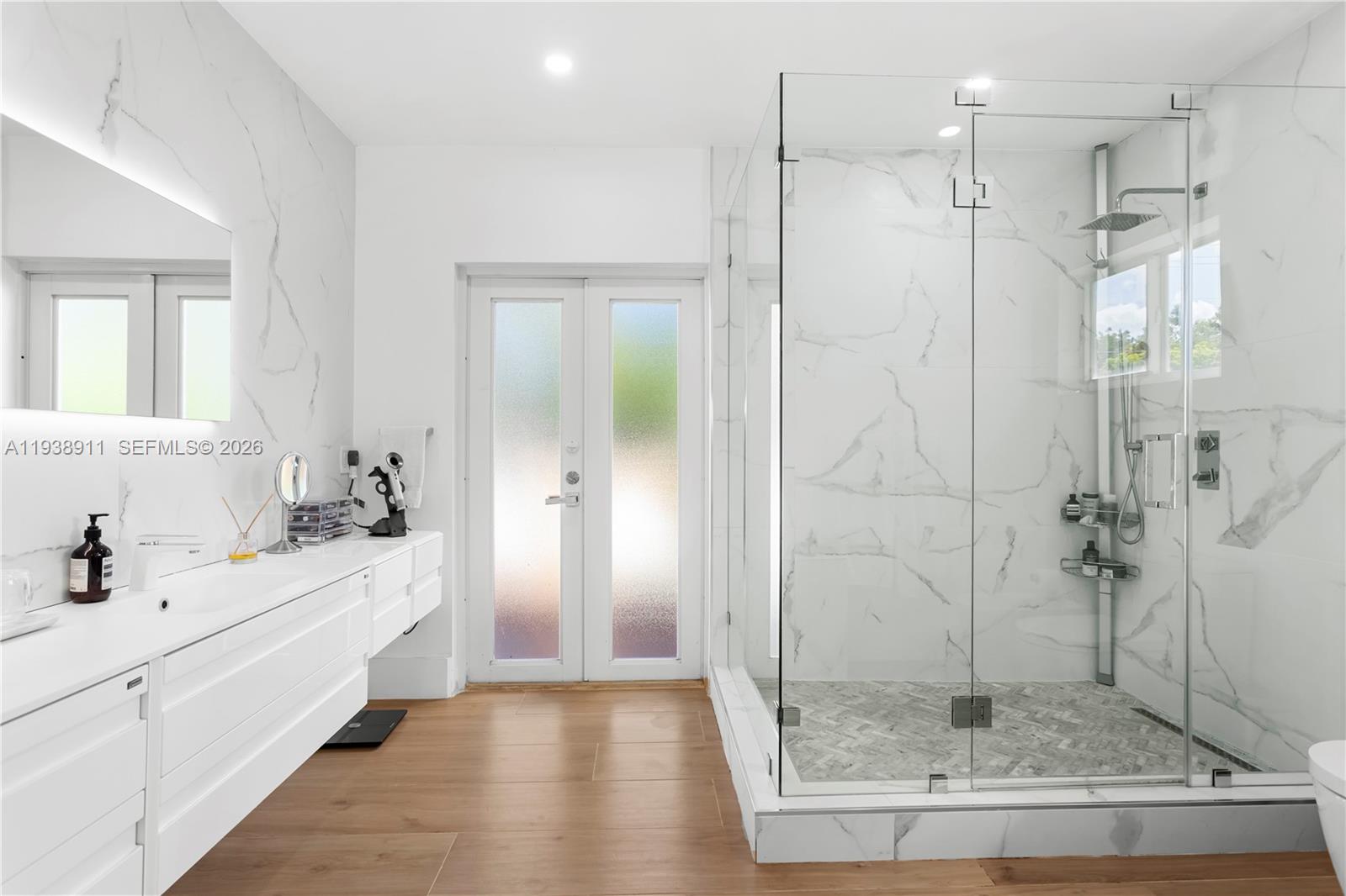 7825 Southwest 72nd Avenue Miami, FL 33143 - Photo 8 of 30 a bathroom with a shower sink and mirror