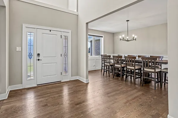a view of a dining area with furniture wooden floor and chandelier