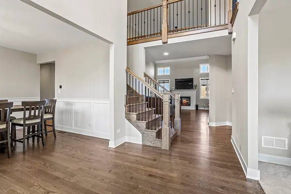 a view of a livingroom with wooden floor and stairs