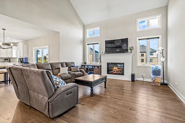 a living room with furniture a flat screen tv and a fireplace