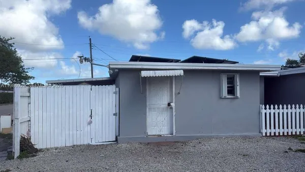 a view of a house with a small yard