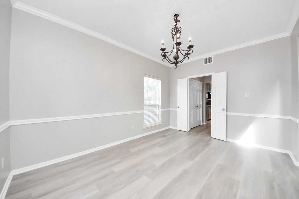 6803 Chapelfield Lane Houston, TX 77049 - Photo 14 of 50 wooden floor in an empty room with a window