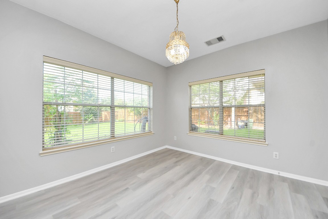 6803 Chapelfield Lane Houston, TX 77049 - Photo 19 of 50 a view of an empty room with a window and wooden floor