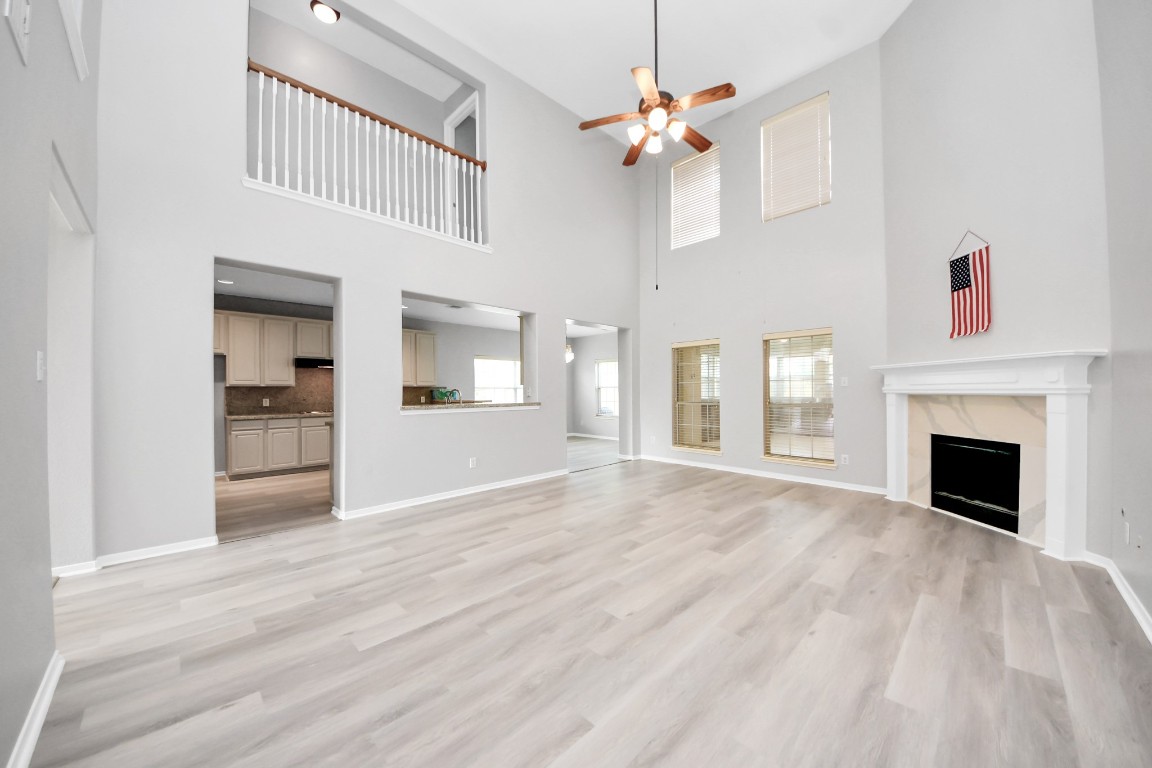 6803 Chapelfield Lane Houston, TX 77049 - Photo 23 of 50 a view of an empty room with chandelier fan and fire place
