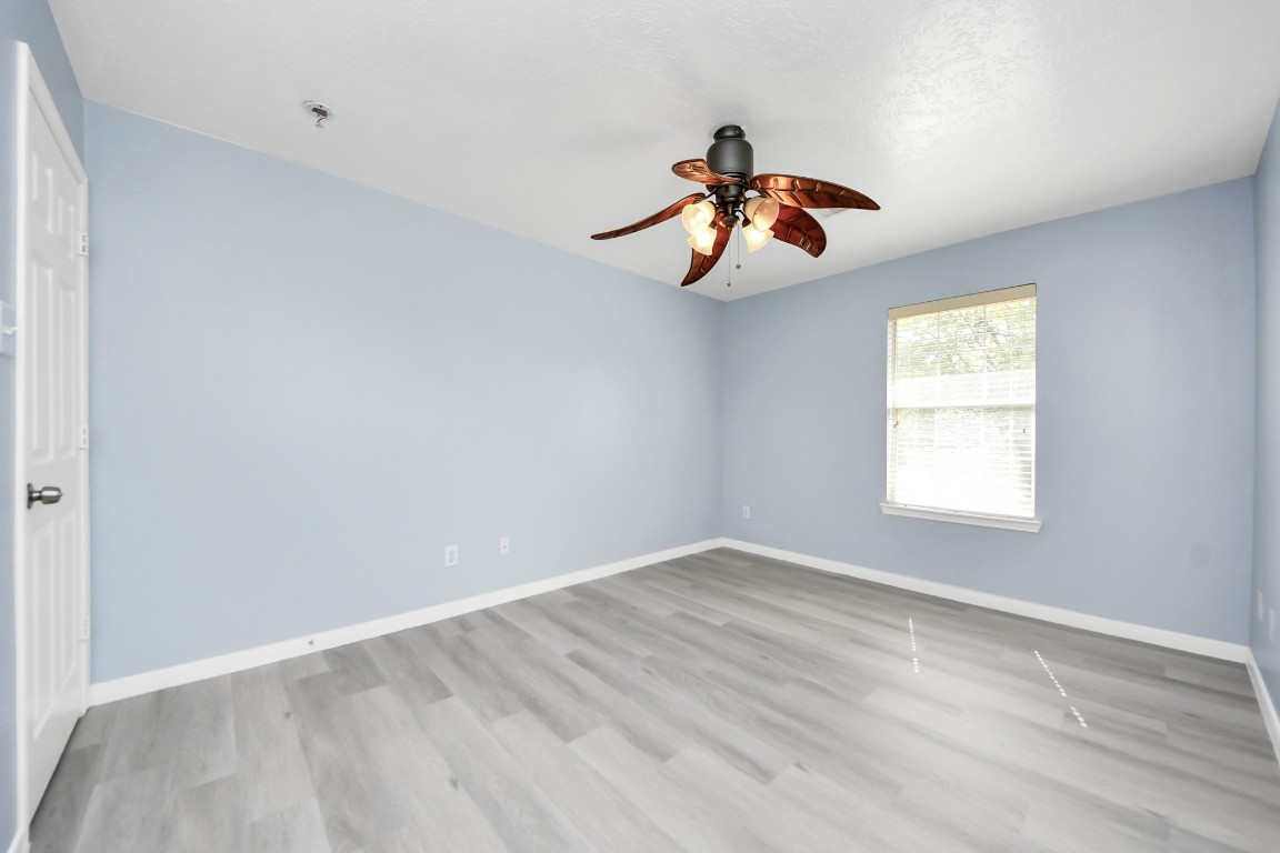 6803 Chapelfield Lane Houston, TX 77049 - Photo 30 of 50 a view of a room with wooden floor and window