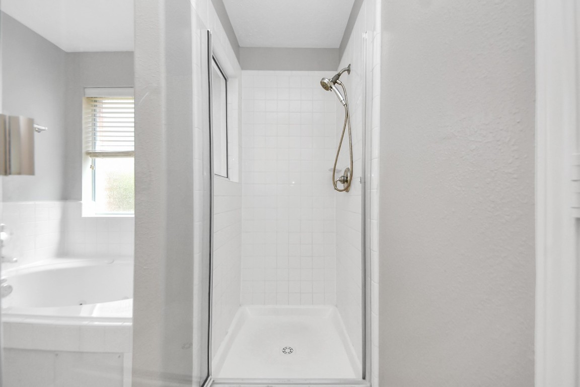 6803 Chapelfield Lane Houston, TX 77049 - Photo 37 of 50 a bathroom with a glass shower door
