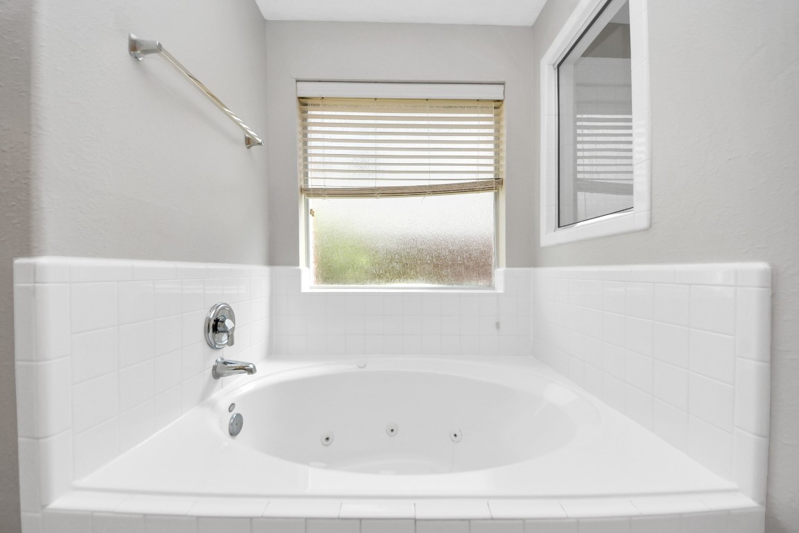 6803 Chapelfield Lane Houston, TX 77049 - Photo 38 of 50 a white bath tub sitting next to a window