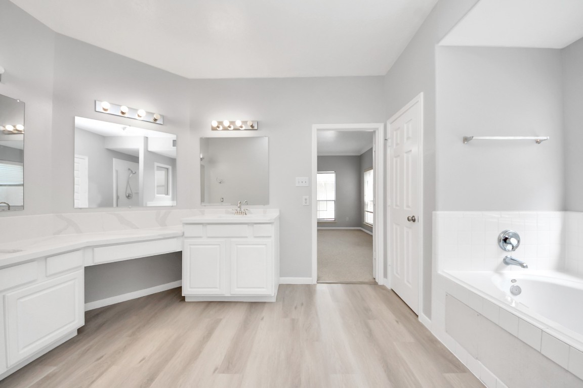 6803 Chapelfield Lane Houston, TX 77049 - Photo 39 of 50 a spacious bathroom with a bathtub double sink and mirror