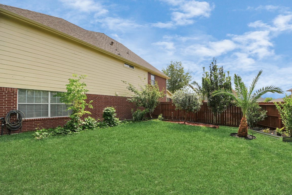 6803 Chapelfield Lane Houston, TX 77049 - Photo 47 of 50 a view of a backyard with plants and a large tree