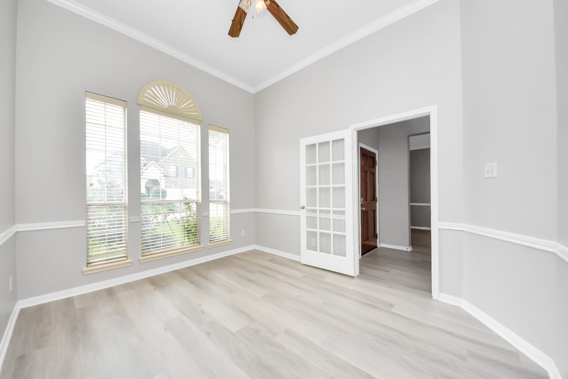 6803 Chapelfield Lane Houston, TX 77049 - Photo 10 of 50 an empty room with wooden floor and windows