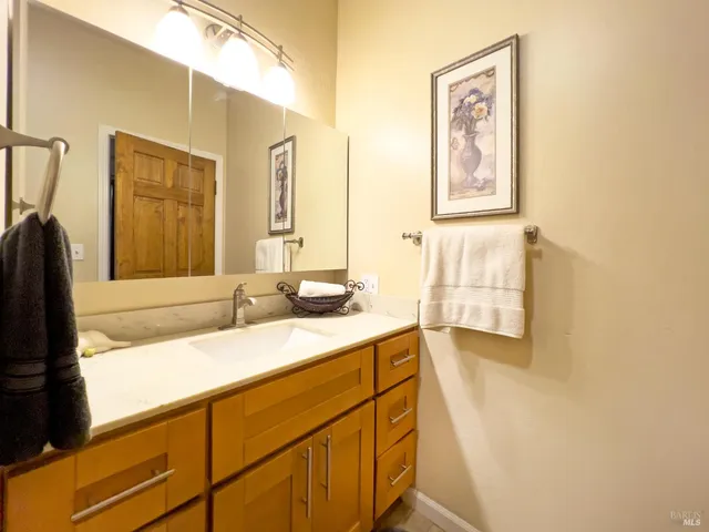 a bathroom with a sink tub and mirror