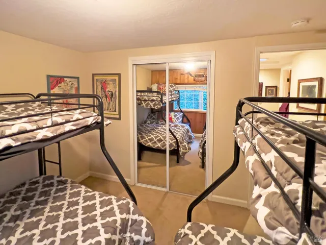 a bed sitting in a bedroom next to a window