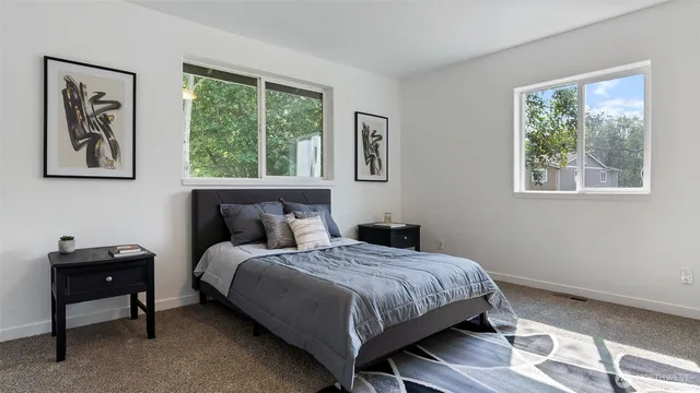 a bedroom with a bed and a window