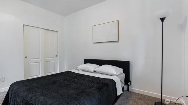 a bedroom with a bed and a closet