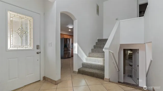 a view of entryway with furniture and front door