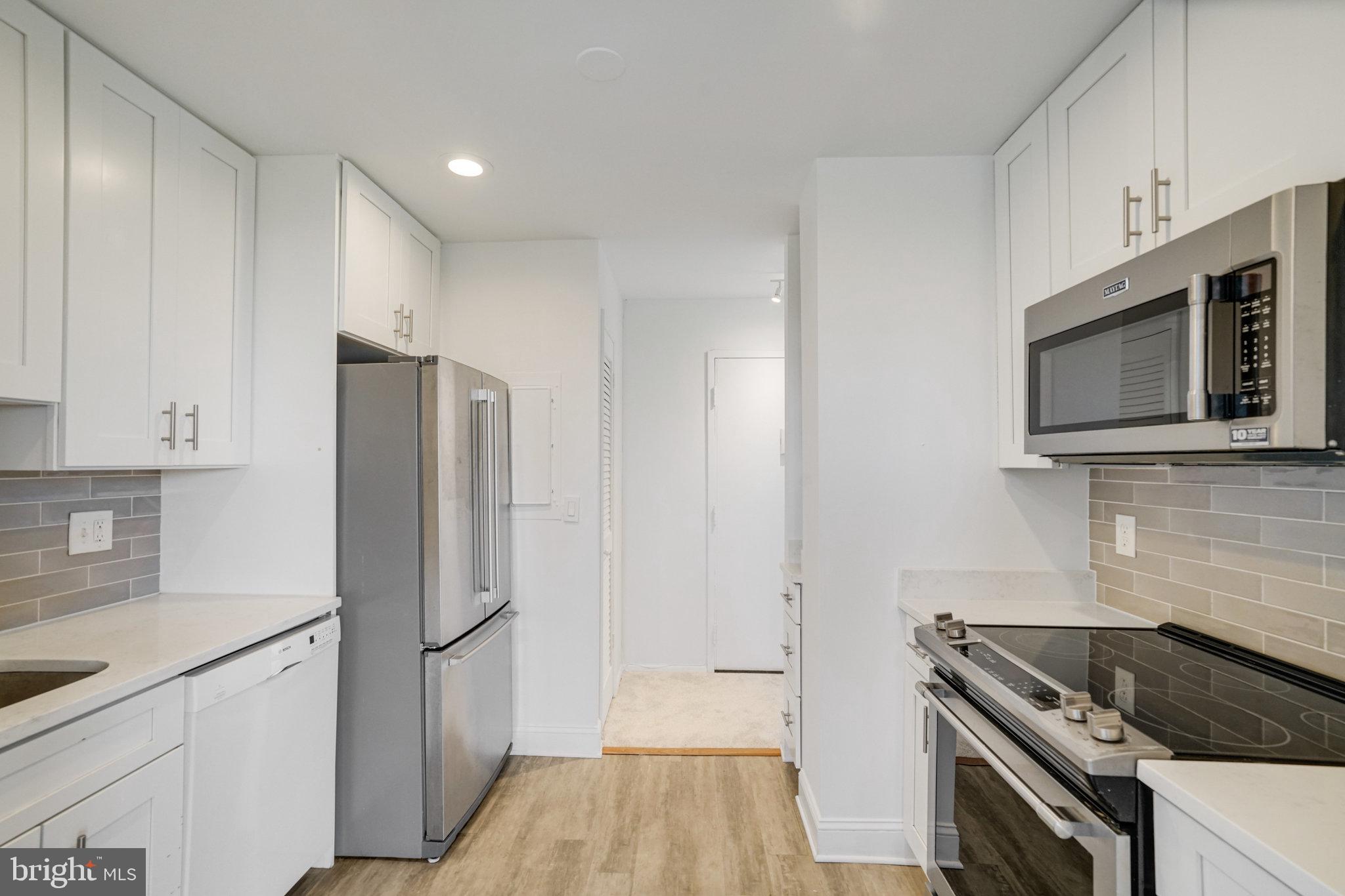 3245 Rio Drive, Unit 901 Falls Church, VA 22041 - Photo 13 of 38 a kitchen with stainless steel appliances a refrigerator stove and microwave