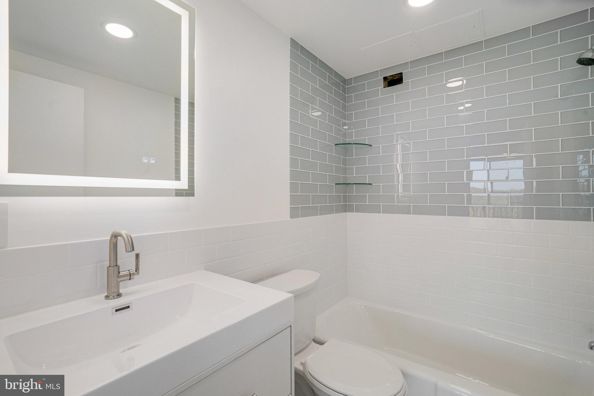 3245 Rio Drive, Unit 901 Falls Church, VA 22041 - Photo 30 of 38 a bathroom with a sink a toilet and shower