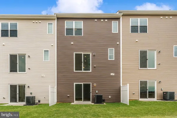 a brick house that has a large windows