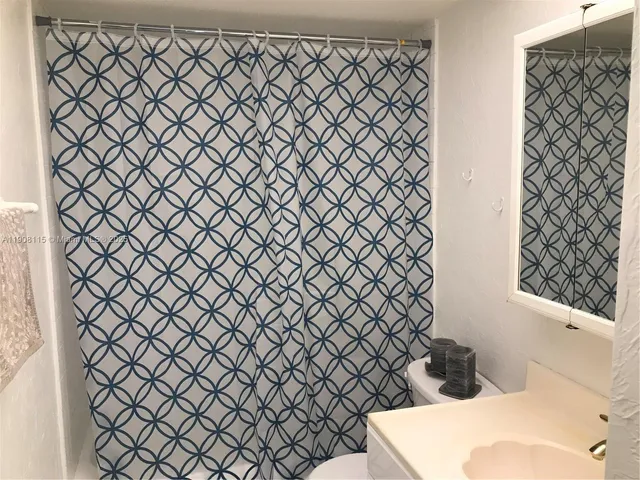 a kitchen with cabinets stainless steel appliances and sink