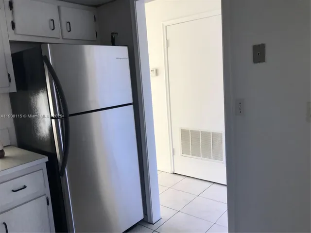 a view of an empty room and wooden floor