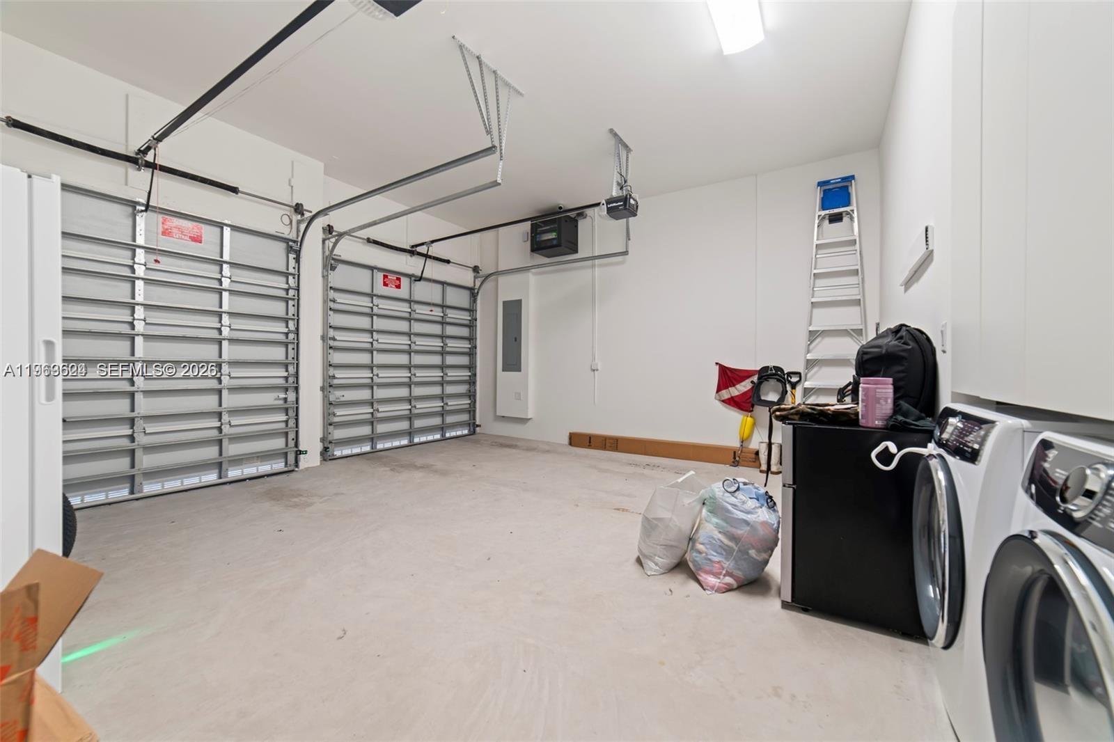 7771 Southwest 99th Street Miami, FL 33156 - Photo 15 of 33 a view of a storage & utility room with washer and dryer