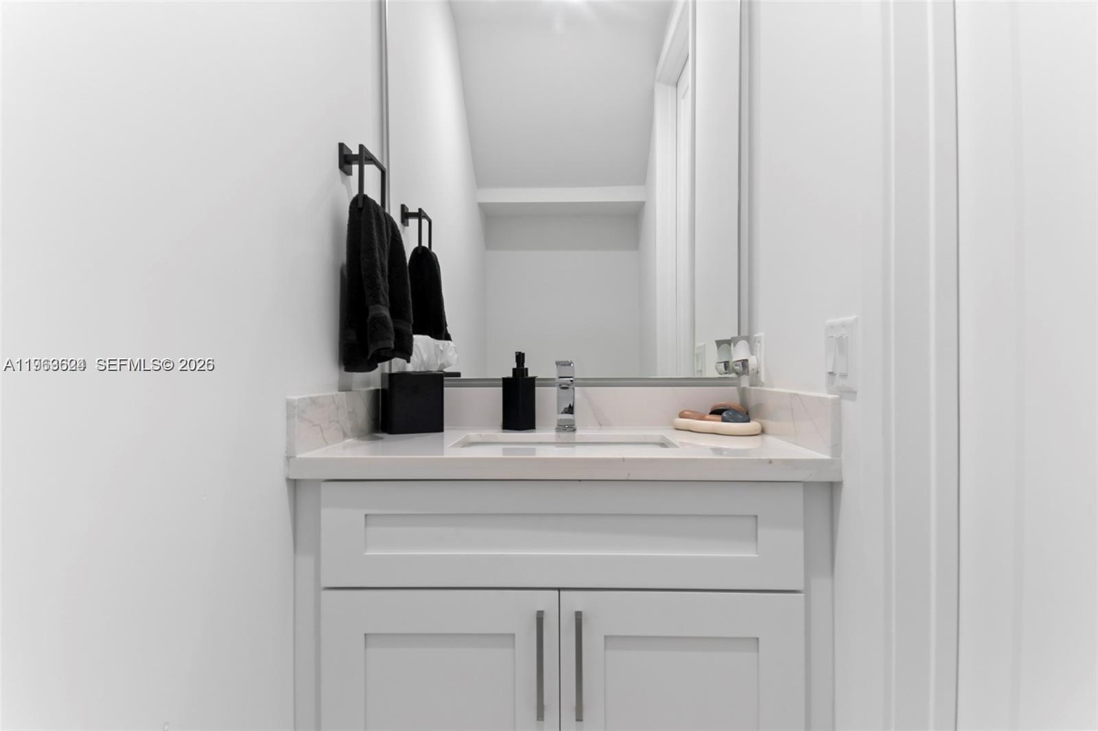 7771 Southwest 99th Street Miami, FL 33156 - Photo 16 of 33 a bathroom with a sink and a mirror