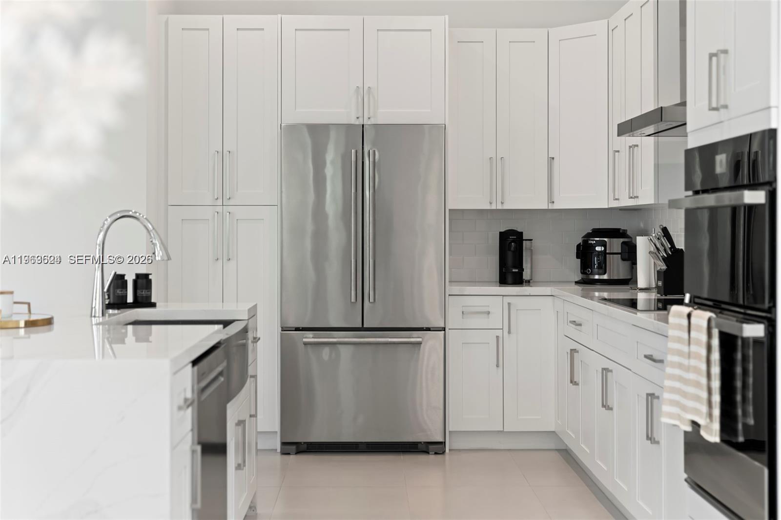 7771 Southwest 99th Street Miami, FL 33156 - Photo 17 of 33 a kitchen with appliances a sink and cabinets
