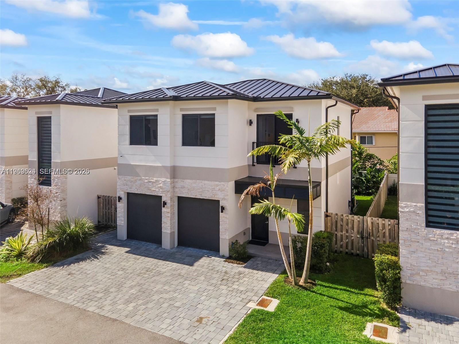 7771 Southwest 99th Street Miami, FL 33156 - Photo 2 of 33 a view of a house with furniture and a garden
