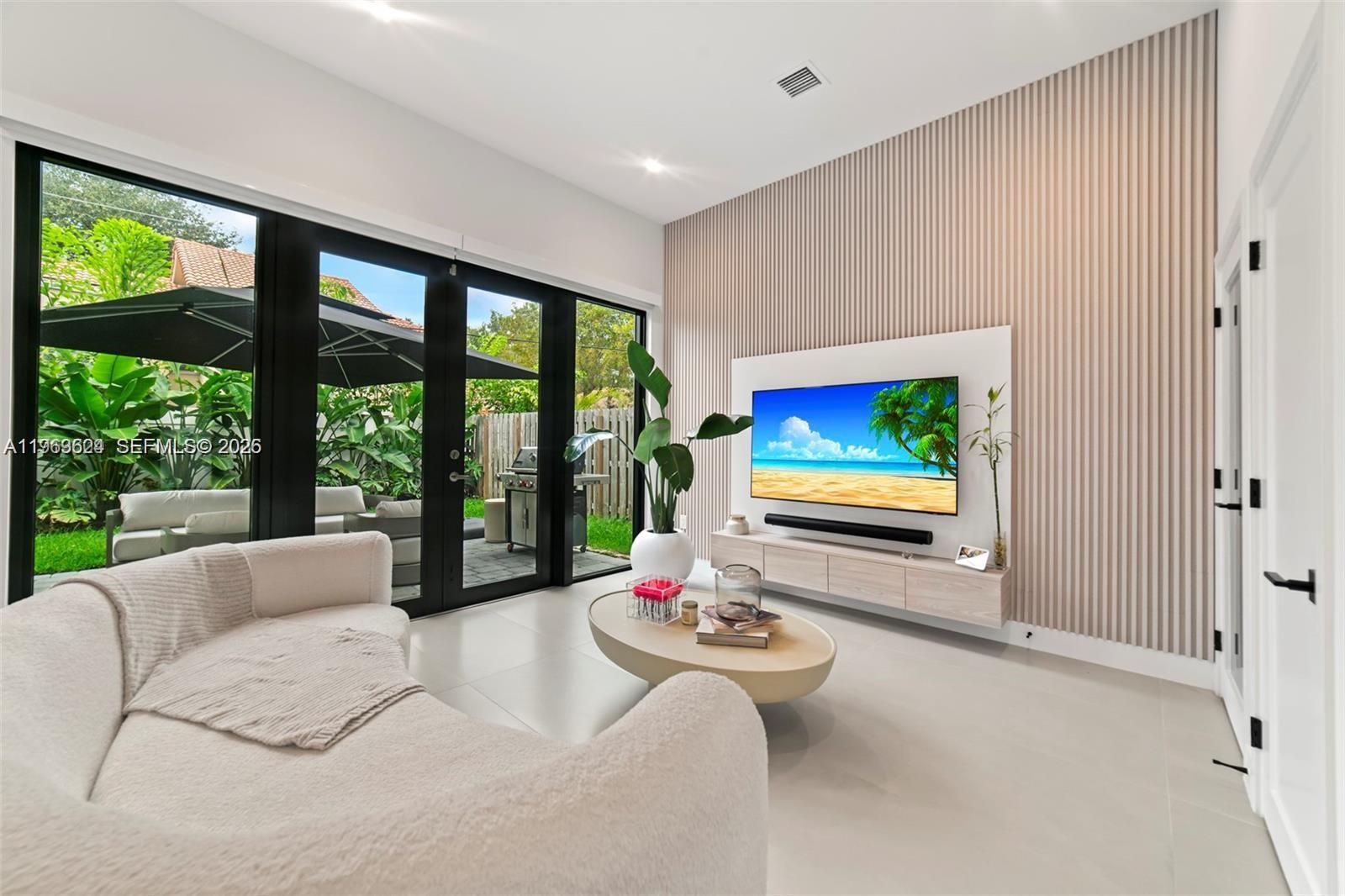 7771 Southwest 99th Street Miami, FL 33156 - Photo 24 of 33 a living room with furniture large window and flat screen tv