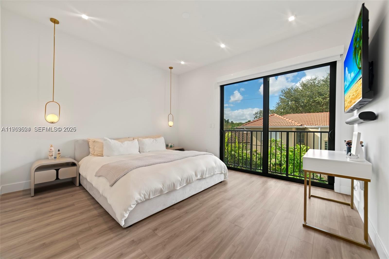 7771 Southwest 99th Street Miami, FL 33156 - Photo 28 of 33 a bedroom with a large bed and a large window