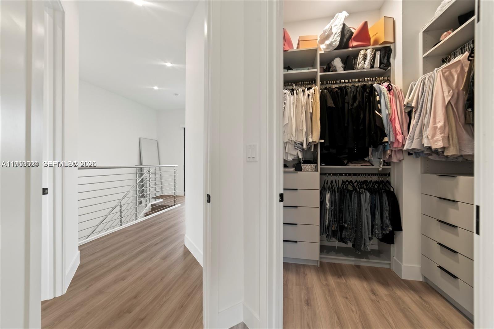 7771 Southwest 99th Street Miami, FL 33156 - Photo 30 of 33 a view of walk in closet with clothes and shoes