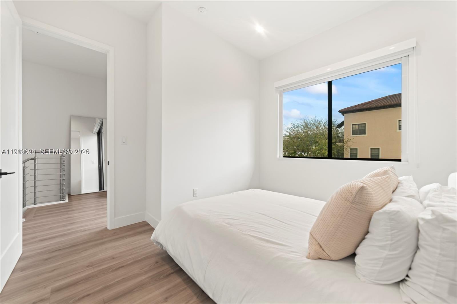 7771 Southwest 99th Street Miami, FL 33156 - Photo 31 of 33 a bedroom with a bed and a mirror