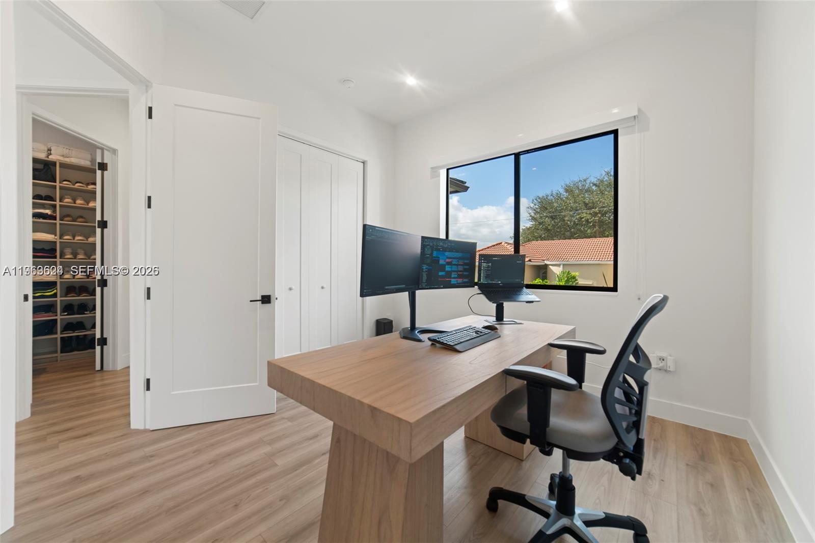 7771 Southwest 99th Street Miami, FL 33156 - Photo 32 of 33 a view of a workspace with furniture and wooden floor