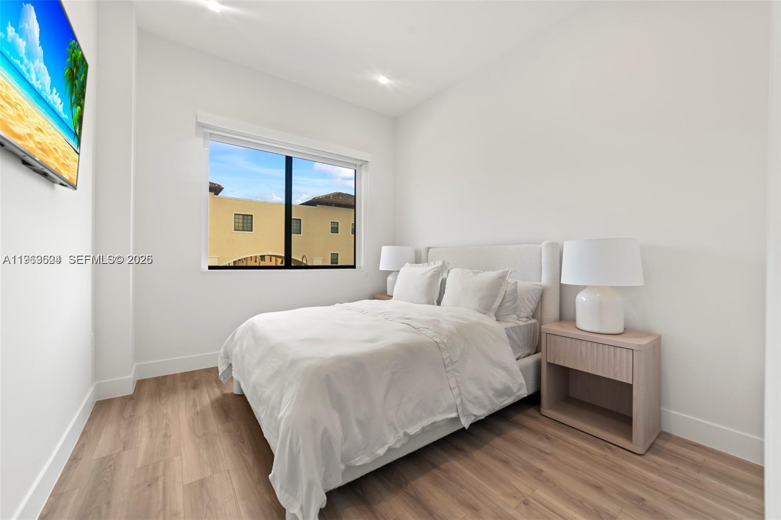 7771 Southwest 99th Street Miami, FL 33156 - Photo 33 of 33 a bedroom with a bed and a painting on the wall