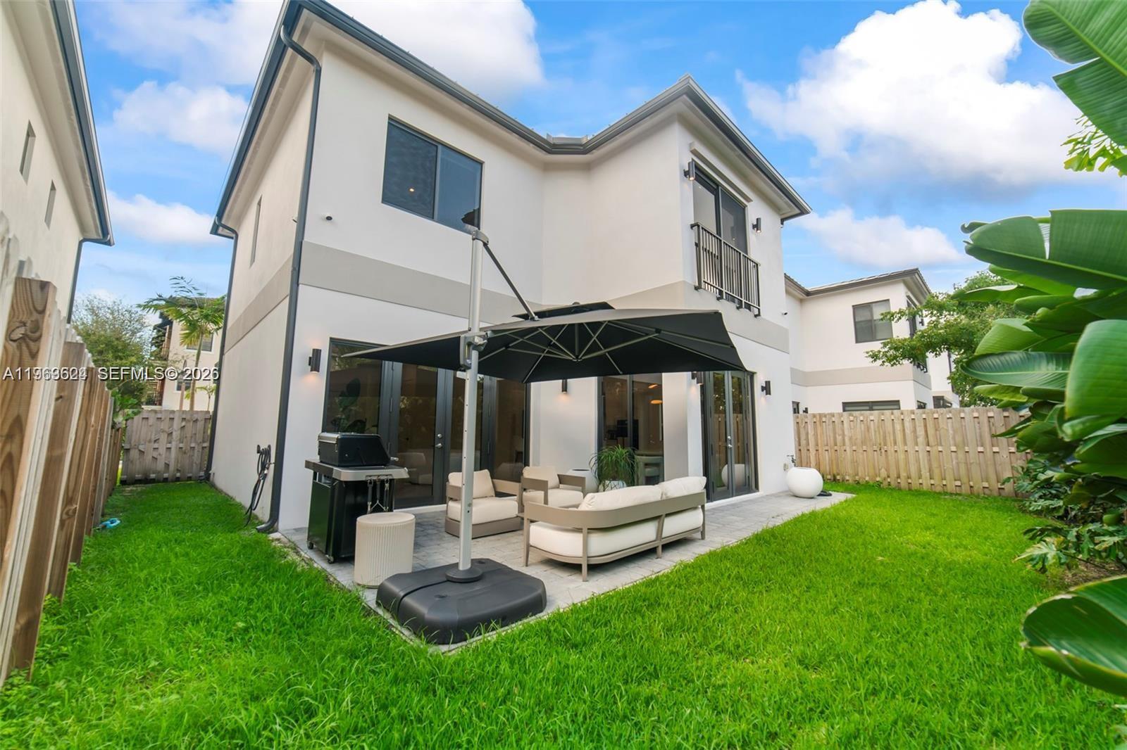 7771 Southwest 99th Street Miami, FL 33156 - Photo 5 of 33 a view of house with backyard and porch