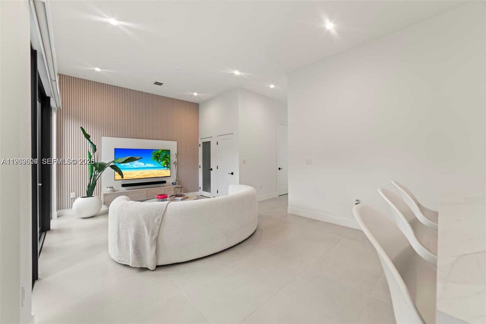 7771 Southwest 99th Street Miami, FL 33156 - Photo 8 of 33 a living room with furniture and a flat screen tv