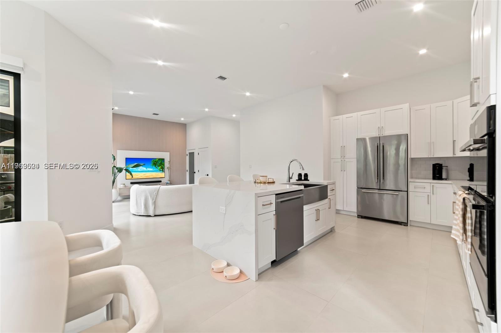 7771 Southwest 99th Street Miami, FL 33156 - Photo 9 of 33 a kitchen with stainless steel appliances a refrigerator a stove a sink and a refrigerator