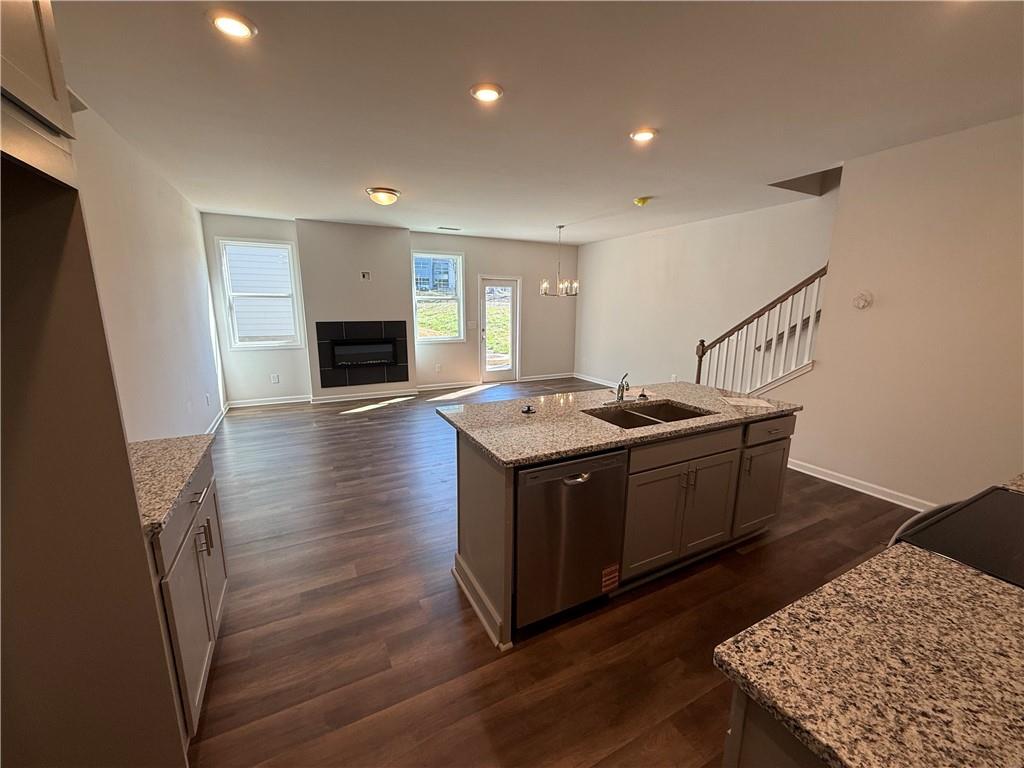 5143 Longview Run Decatur, GA 30035 - Photo 6 of 17 a kitchen with stainless steel appliances granite countertop a sink dishwasher a stove and a wooden floor