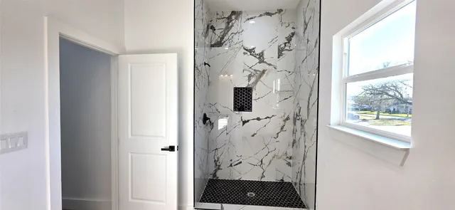 a bathroom with a toilet a sink and a window