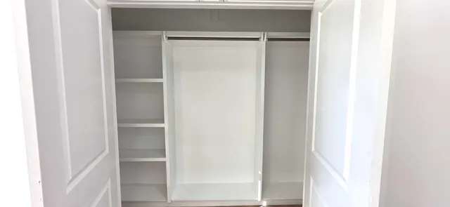 a close view of closet with wooden floor