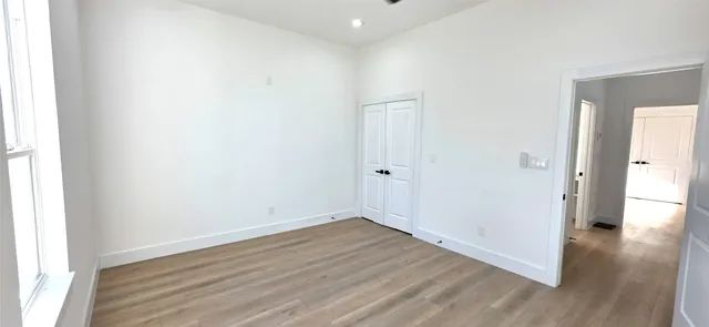 a view of an empty room and wooden floor