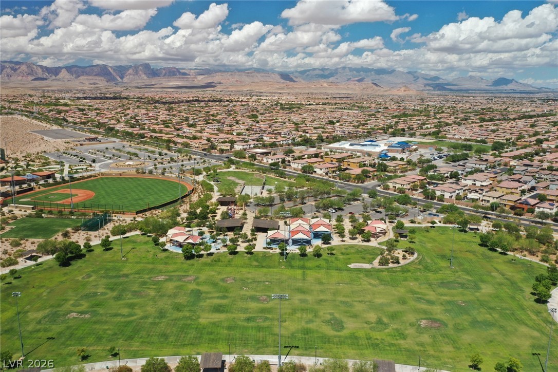 9916 Sable Point Street Las Vegas, NV 89178 - Photo 71 of 73 Vast green fields and sports facilities await, nestled within a sprawling community under expansive skies.