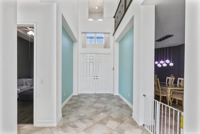 a dining room with furniture a chandelier and wooden floor