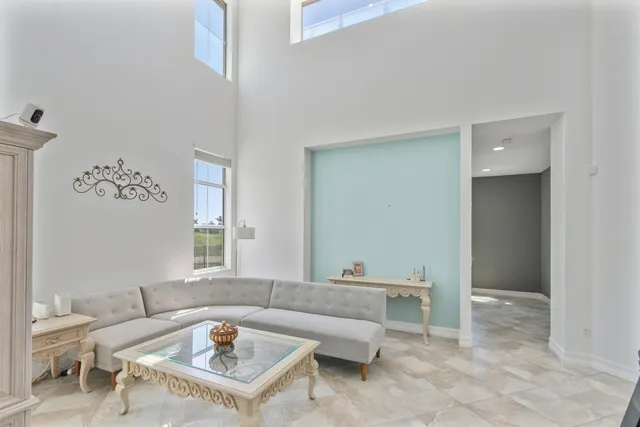a bathroom with a granite countertop sink a toilet a mirror a vanity and shower
