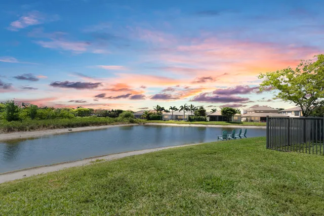 a view of lake with houses in the back