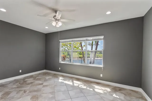 a bathroom with a granite countertop sink toilet a large mirror a bathtub and shower