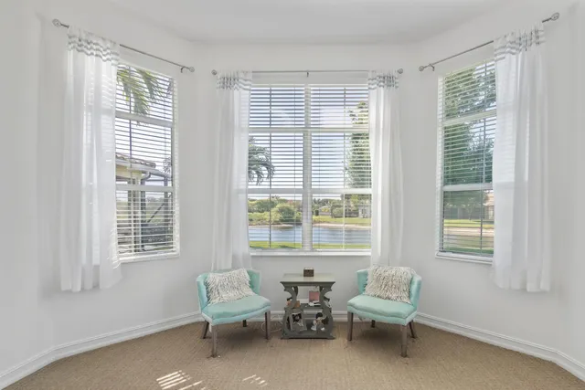 an aerial view of a city with lots of residential buildings ocean and mountain view in back